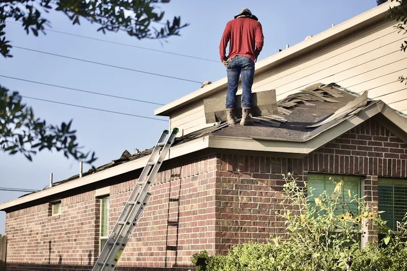 Professional roofer working on a residential roof in Fulshear